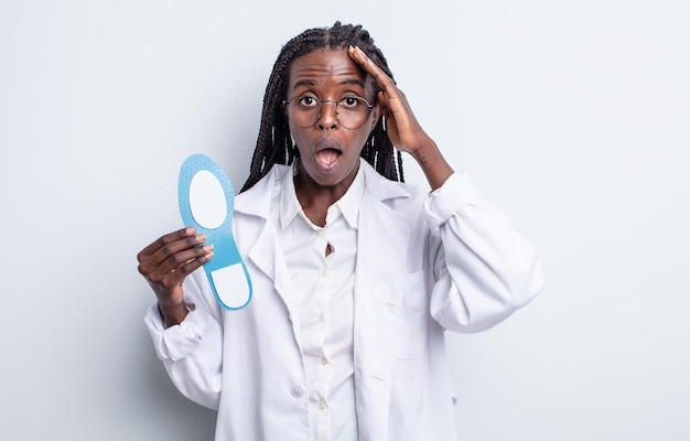 Pretty black woman looking happy, astonished and surprised. podiatrist concept
