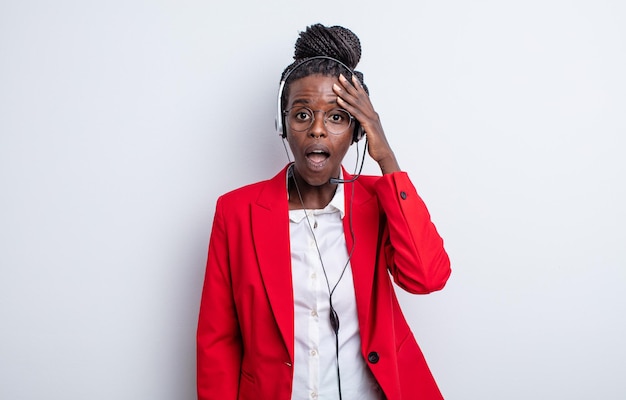 Pretty black woman looking happy, astonished and surprised. telemarketing concept