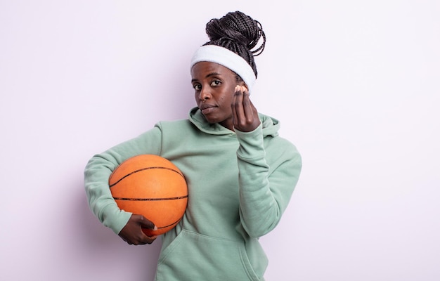 Pretty black woman making capice or money gesture telling you to pay basketball concept