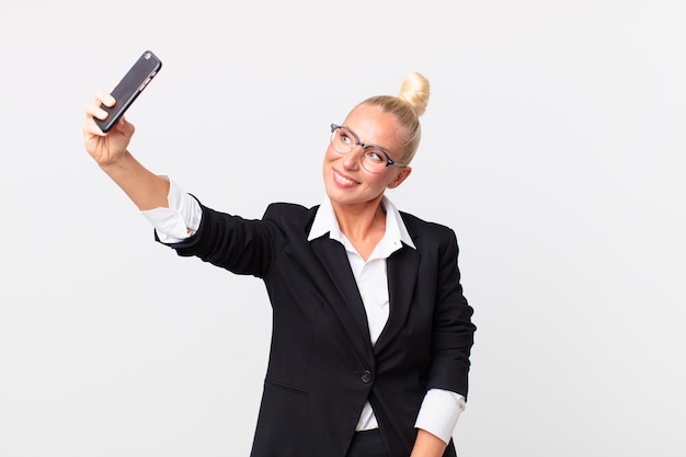 Pretty blond businesswoman with a smartphone