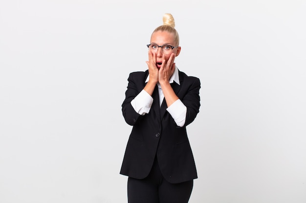 Pretty blond woman feeling shocked and scared. business concept