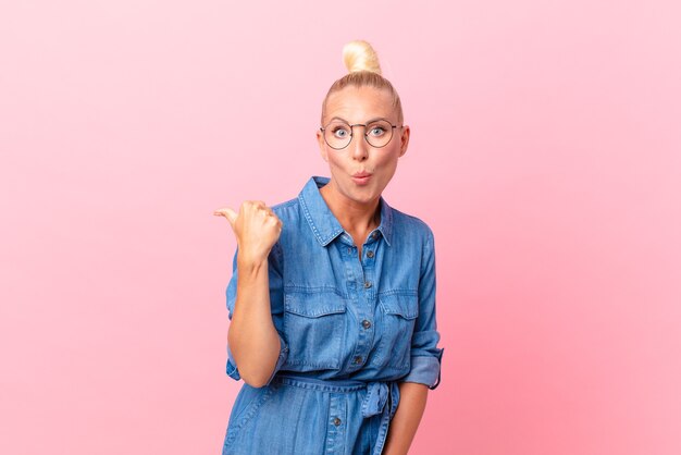 pretty blond woman looking astonished in disbelief