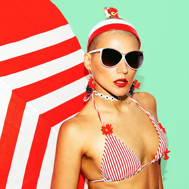 Pretty Blonde Beach Style. Fashionable swimsuit and accessories. Club party vibes