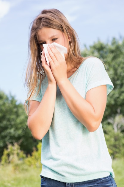 Pretty blonde blowing her nose