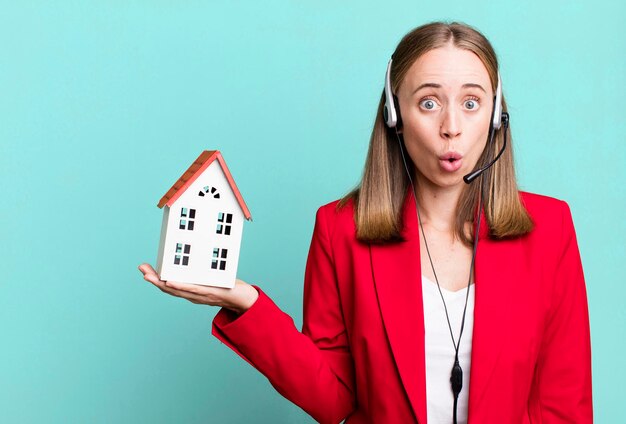 Pretty blonde businesswoman real state telemarketer concept