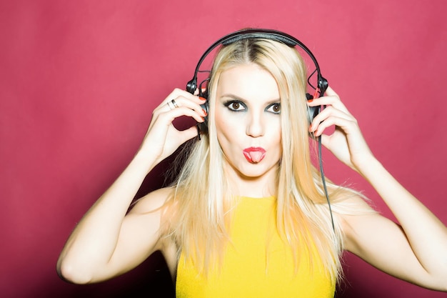 Pretty blonde dg girl in headset on pink