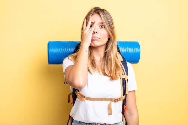 Pretty blonde girl feeling bored, frustrated and sleepy after a tiresome.  hiker concept