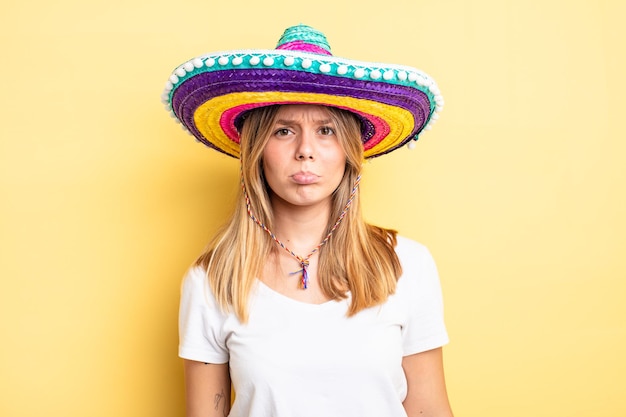 Pretty blonde girl feeling sad and whiney with an unhappy look and crying. mexican hat concept