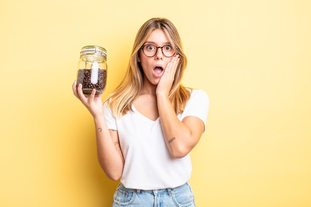 Pretty blonde girl feeling shocked and scared. coffee beans concept