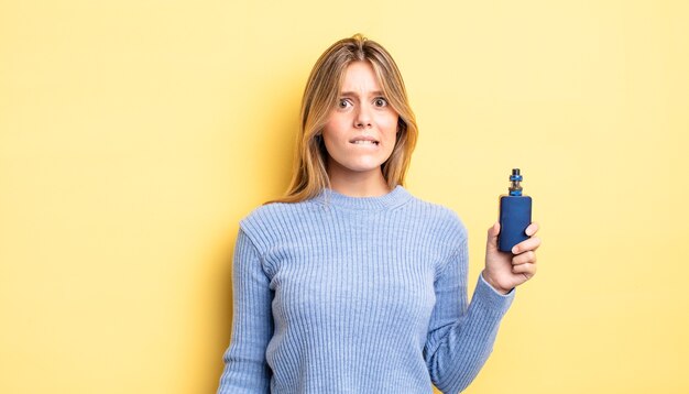 pretty blonde girl looking puzzled and confused. smoke vaporizer concept