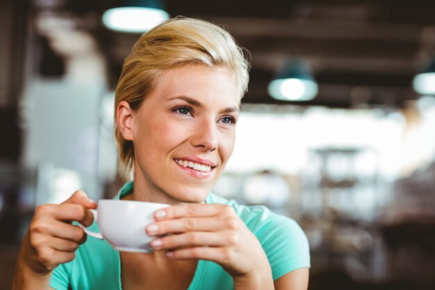 Pretty blonde holding cup of coffee