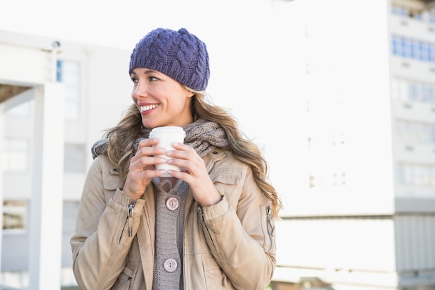 Pretty blonde holding take-away cup