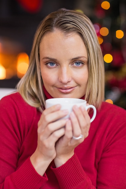 Pretty blonde relaxing on sofa at christmas