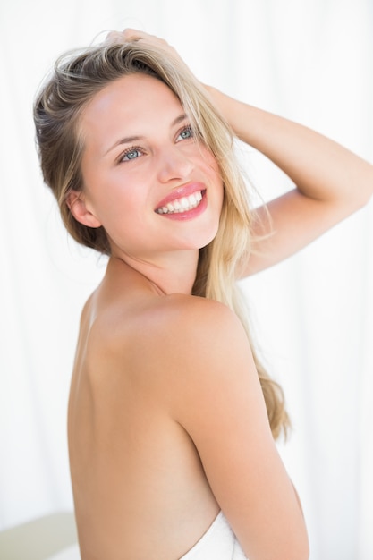 Pretty blonde sitting on massage table