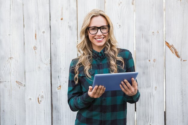 Pretty blonde with glasses using tablet