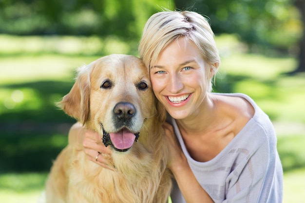 Pretty blonde with her dog in the park 