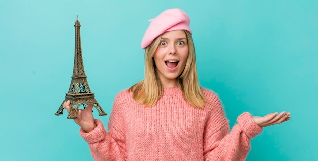 Pretty blonde woman feeling happy surprised realizing a solution or idea france concept