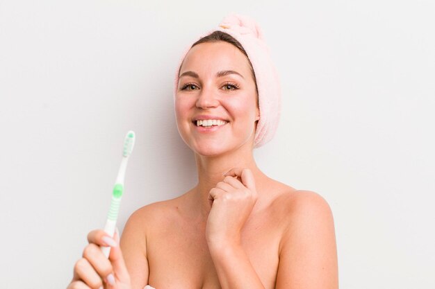 Pretty blonde woman holding a toothbrush