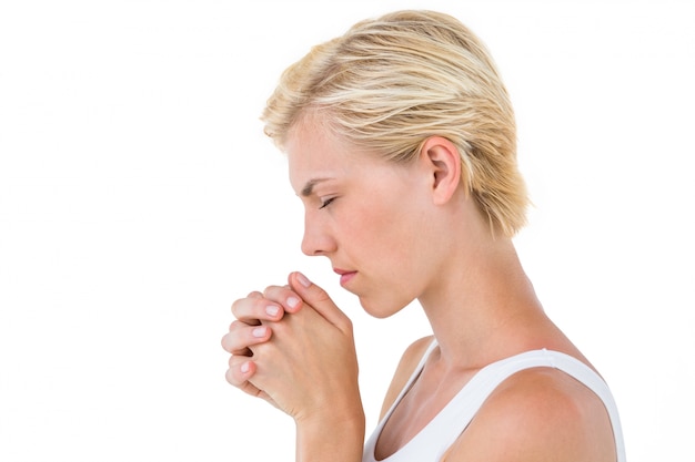 Pretty blonde woman praying