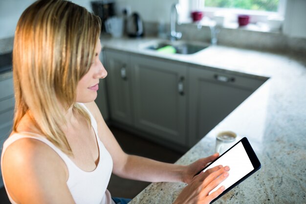 Pretty blonde woman using tablet computer