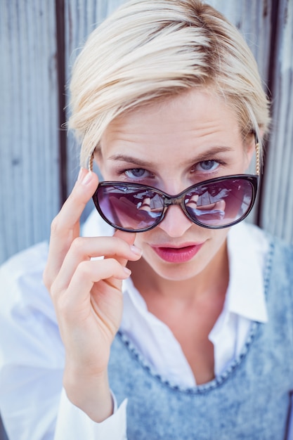 Pretty blonde woman wearing sun glasses