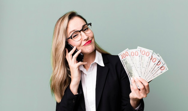 Pretty blonde woman with dollar banknotes