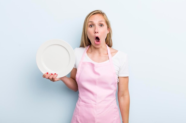 Pretty blonde woman with an empty dish chef concept