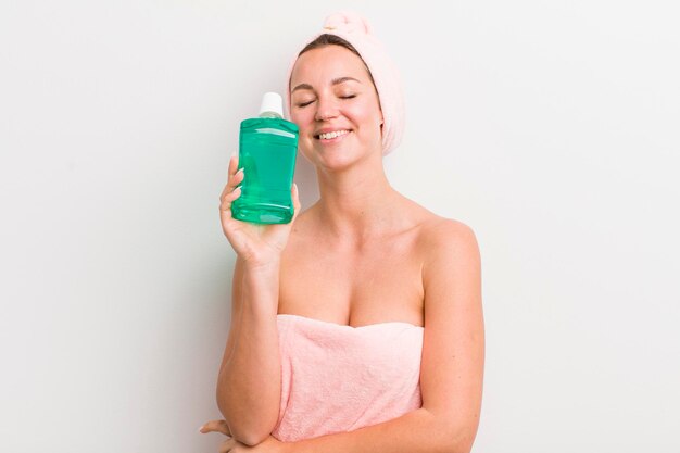 Pretty blonde woman with a mouth wash bottle