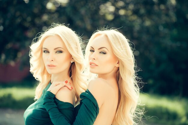 Pretty blonde women in green dresses