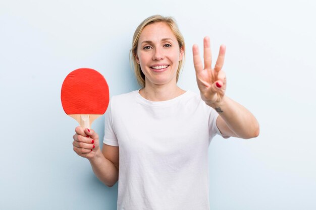 Pretty blonde young adult woman ping pong concept