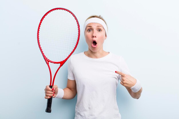 Pretty blonde young adult woman tennis sport concept