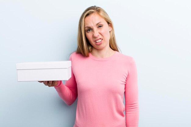 Pretty blonde young adult woman with a take away pizza box