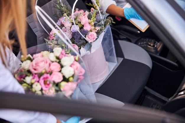 Pretty bouquets of flowers being delivered in a car