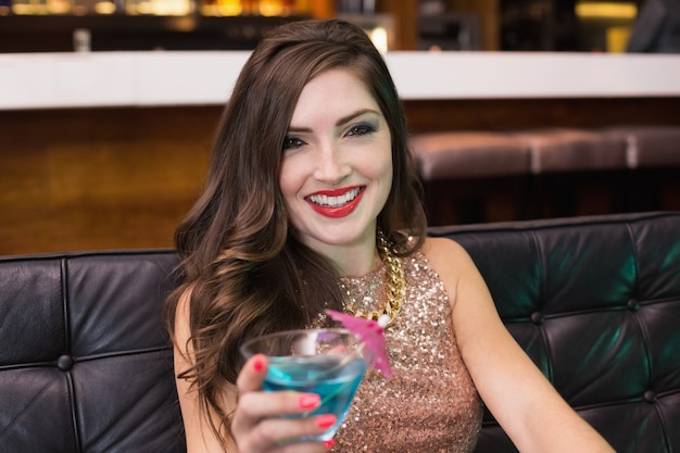 Pretty brunette drinking a cocktail