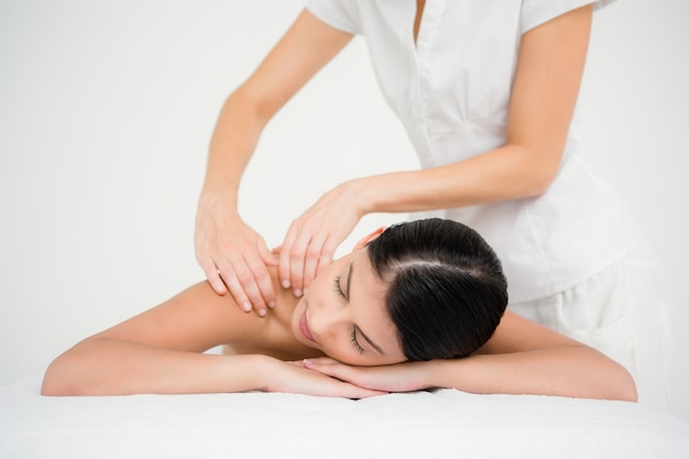 Pretty brunette enjoying a massage