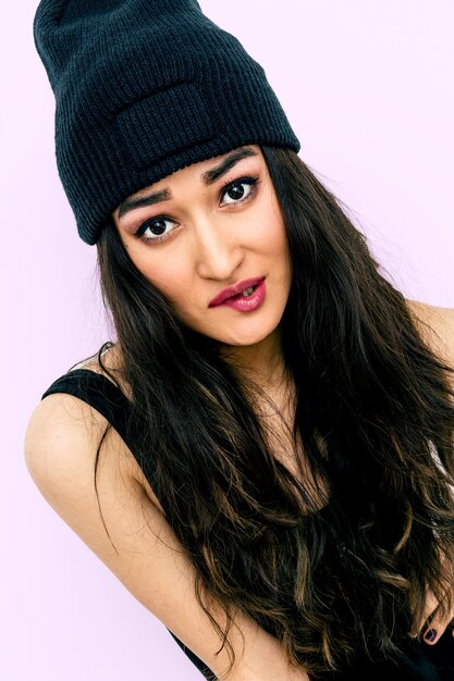 Pretty brunette Girl in black beanie cap. Swag Urban Style