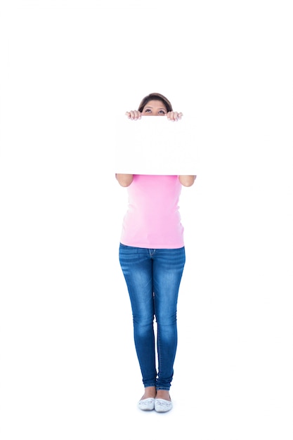 Pretty brunette holding blank sign in front of her head