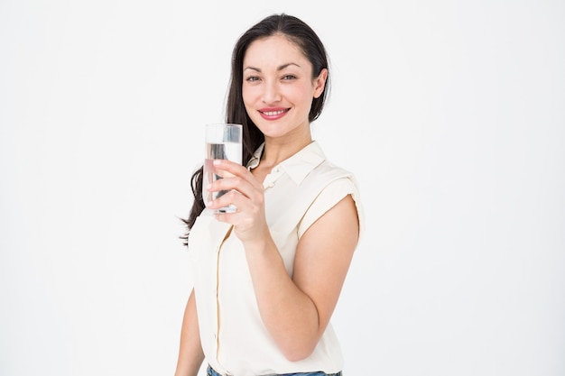 Pretty brunette holding glass of water 