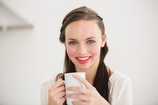 Pretty brunette holding a mug