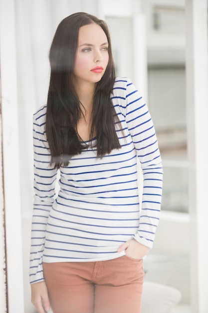 Pretty brunette looking out window