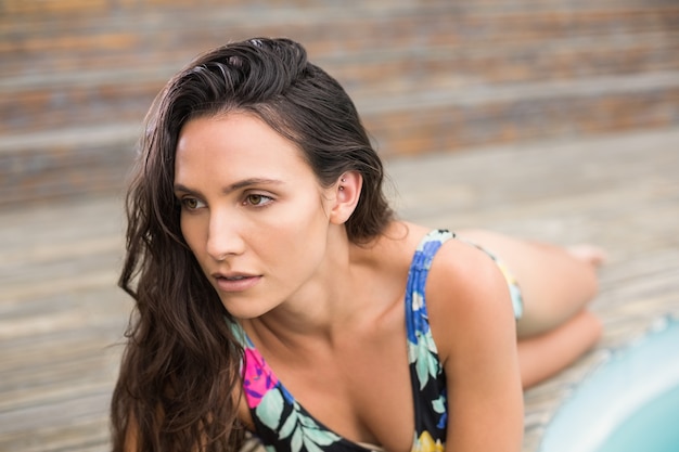 Pretty brunette lying in swimwear 