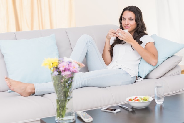 Pretty brunette relaxing on couch