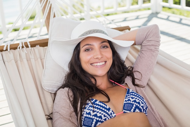 Pretty brunette relaxing on a hammock