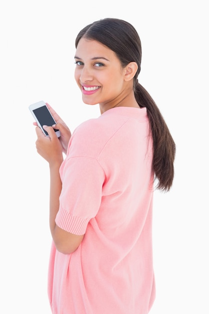 Pretty brunette sending a text message