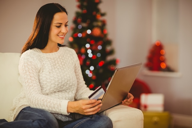 Pretty brunette shopping online at christmas