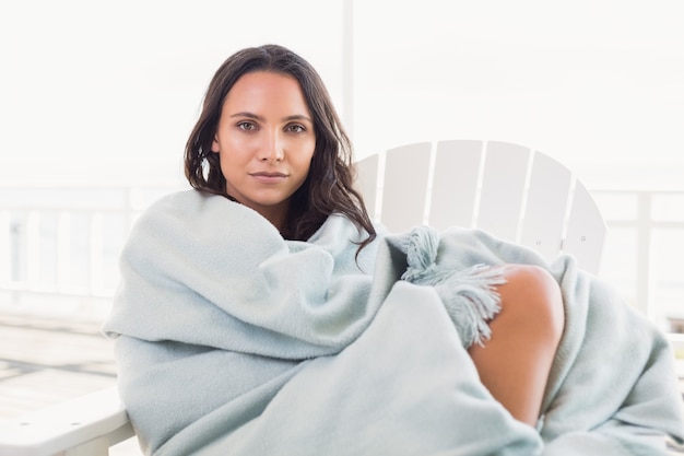 Pretty brunette sitting on a chair 