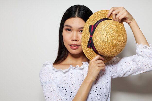 Pretty brunette in white shirts hat fashion posing light background unaltered