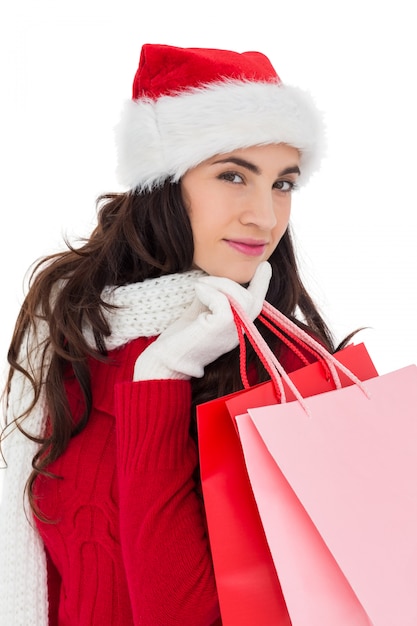 Pretty brunette in winter wear holding shopping bags