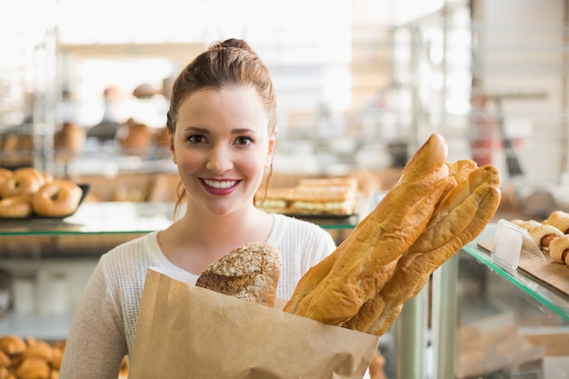 Pretty brunette with bag of bread