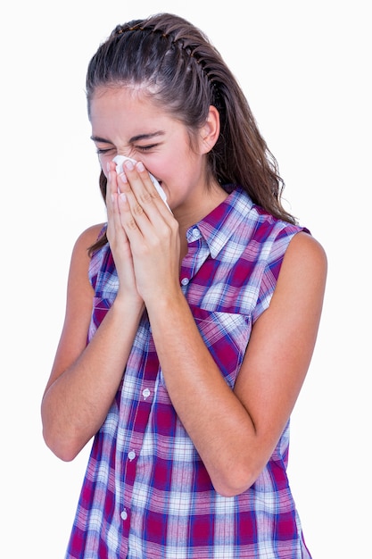 Pretty brunette woman blowing her nose 